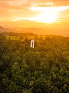 Tower in the middle of a forest under an orange-coloured sky at sunset, Schönberg Tower,