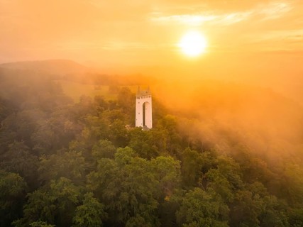 Foggy morning with tower surrounded by trees as the sun rises, Schönberg Tower, Pfullingen, Swabian