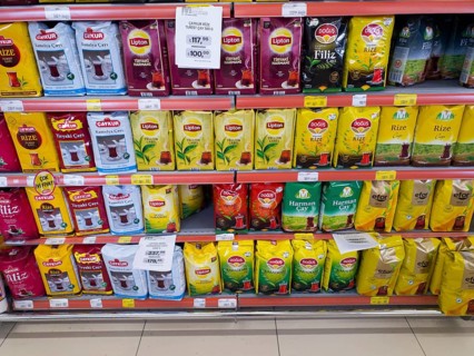 Various tea brands displayed in colourful packaging on a supermarket shelf, tea for sale, Turkey