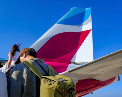 Mykonos, Greece - EUROWINGS. At Mykonos Airport, holidaymakers board a Eurowings aircraft via an