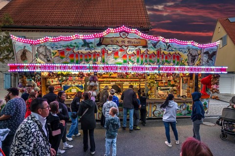 Shooting gallery in the evening at the church fair in the village of Eschenau, Middle Franconia,