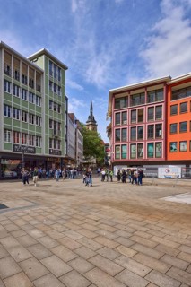 Square, general architecture, pavement slabs, trees, steeple of the collegiate church Stuttgart,