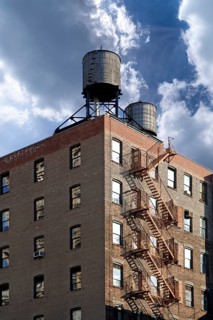 Residential tower with wooden water tanks on the roof, New York City, USA