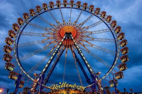 Dark clouds behind the illuminated Ferris wheel, Festwiese, Theresienwiese, Oktoberfest, Munich,