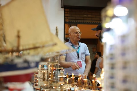 Syrian artisans display handmade artistic pieces to visitors at the Damascus International Fair.