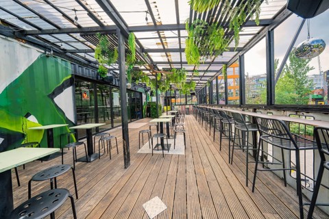 Modern industrial-style terrace with plants, bar and seating, Werksviertel Munich, Munich, Germany