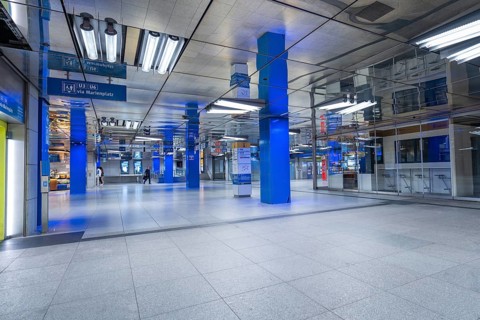 Empty underground building with reflections and blue poles, Münchner Freiheit, Munich, Germany