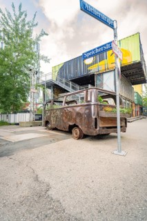 Industrial area with old, planted bus and container buildings in the background, Werksviertel