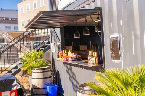 Close-up view of a snack bar in a container with barrels and plants, open-air cinema Sindelfingen,