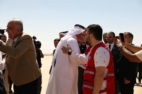Officials from the Qatari and Syrian Red Crescents receive a Qatari airlift of aid to help the