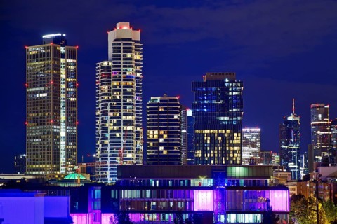Rooftop day with colourfully illuminated houses for a techno party on the roof with a view of the