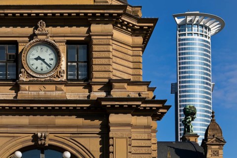 Side front of the main railway station with Atlas carrying the globe on his shoulders in front of