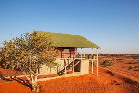 Some of the chalets of the Bagatelle Kalahari Game Ranch are built on top of a sand dune. Kalahari
