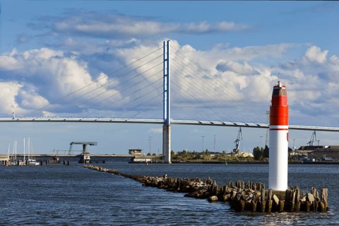 In front sea mark, beacon, harbour entrance, behind it Rügen bridge, connects island Rügen with
