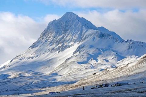 Snowy mountain under blue sky with winter landscape in the foreground, North Iceland, Iceland