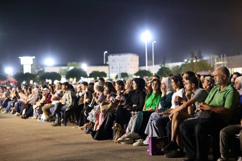 Audience members enjoy a musical performance during the Damascus International Fair in Damascus,
