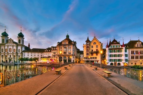View of Lucerne's old town with Jesuit church from the Reuss bridge at dawn, Canton of Lucerne,