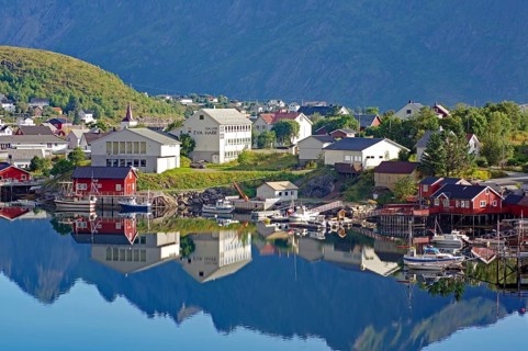 Small village with colourful houses and harbour facilities, picturesquely situated on the water,