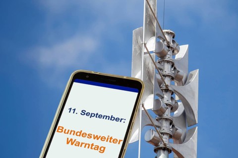 (Photomontage) Close-up of a siren, next to it an open smartphone with text 11 SEPTEMBER: FEDERAL