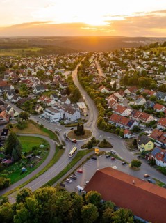 Urban settlement with red roofs and winding streets in the setting sun, small town pearl Calw,