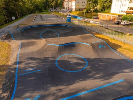 A pump track marked with blue lines in a green, urban environment, pump track, Nagold, Black