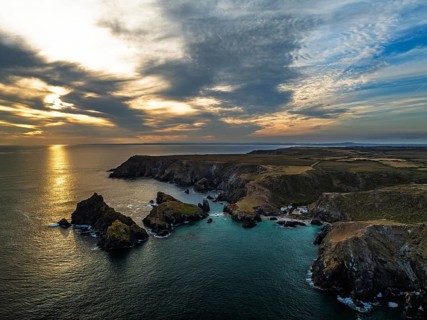 Sunset over Kynance Cove from a drone, Mount's Bay, Lizard Point, Cornwall, England, United Kingdom