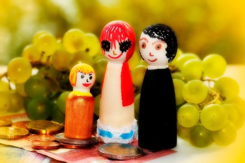Wooden cone family with grapes and coins and banknotes, alienation, North Rhine-Westphalia, Germany