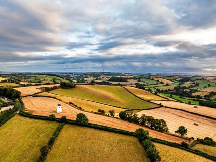 Sunset of Fields and Farms over Devon from a drone, Torquay, Torbay, Devon, England, United Kingdom