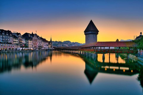 Chapel bridge with water tower reflected in the river Reuss, Lucerne old town at dawn, Canton