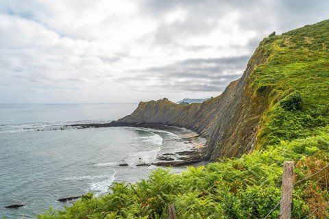Breathtaking view of the flysch cliffs meeting the ocean waves at sakoneta beach in zumaia, a