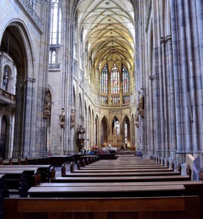 Tourists admiring the stained glass windows and gothic architecture of st. Vitus cathedral in