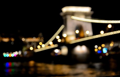 Blurred lights highlighting the chain bridge in budapest, hungary at night, reflecting in the