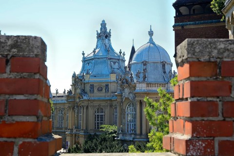 Architectural detail of vajdahunyad castle seen through brick battlements on a sunny day in