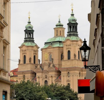 Church towers rising above the cityscape of prague, showcasing the city's rich architectural