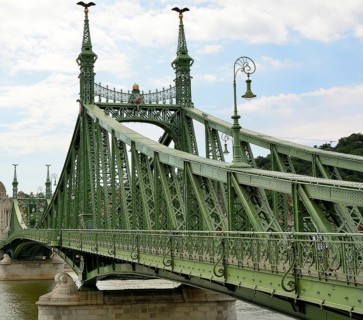 Liberty bridge, a green steel bridge, is standing over danube river in budapest, hungary,