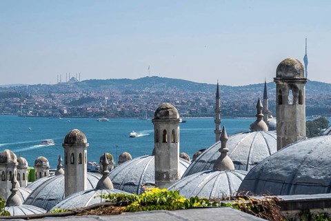 Traditional ottoman architecture dominates the foreground, with the bosphorus strait and the asian
