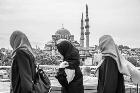 Three muslim women walking through istanbul, admiring the stunning suleymaniye mosque in the