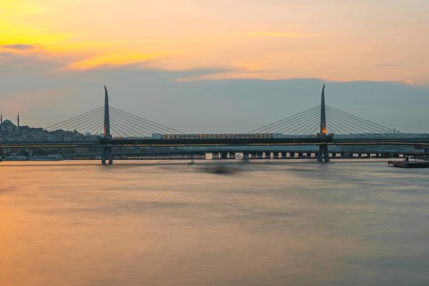 Long exposure of a metro train crossing the golden horn metro bridge in istanbul, turkey, during a