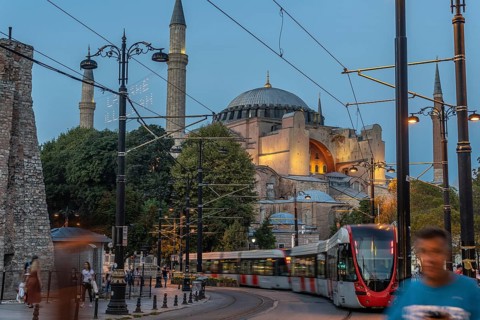 Modern tram passing in front of the ancient hagia sophia mosque in istanbul, turkey, during a