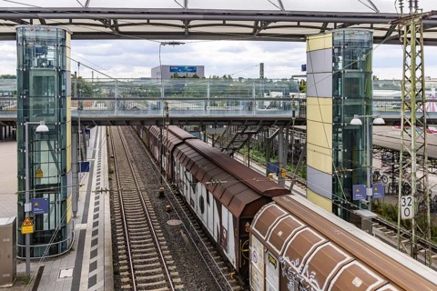 Railway station with passing goods train in Walldorf-Wiesloch. Wiesloch, Baden-Württemberg, Germany