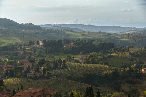 Village and fields in the soft evening light of the Tuscan countryside in San Gimignano, Italy