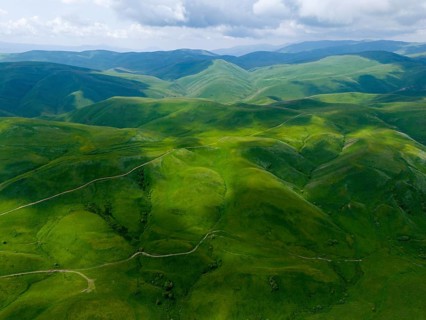 Green hills stretch under a cloudy sky, picturesque landscape, aerial view, Dilijan National Park,
