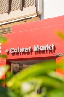 Calw market sign on a modern building, framed by plants, small town pearl Calw, Black Forest,