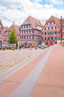 View of a picturesque market square with half-timbered houses in historical style, small town of