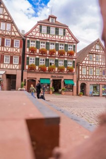 Inviting atmosphere with half-timbered houses and floral decorations, small town pearl Calw, Black