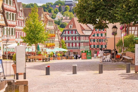 Sunny pedestrian zone with half-timbered houses and inviting café, small town pearl Calw, Black
