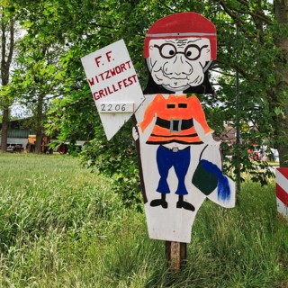 Funny sign with fireman figure and water bucket, inscription, invitation to barbecue, volunteer