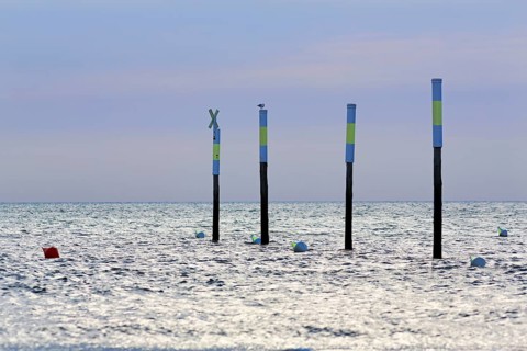 Four poles in a row, marker, sea mark, buoys, evening sky, Sankt Peter-Ording, Eiderstedt