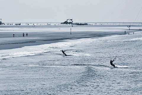 Two kitesurfers in the evening, monochrome, Sankt Peter-Ording, Eiderstedt peninsula, Wadden Sea