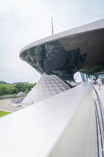 Futuristic building with curved roof and characteristic glass structures, BMW Welt, Munich, Germany